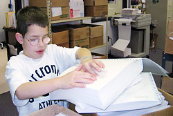 Kevin scanning new braille book titles