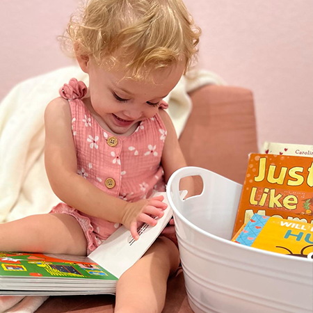 emma Photo of a 1 year old girl reading Good Night Moon. Her hand is on the page feeling the braille.