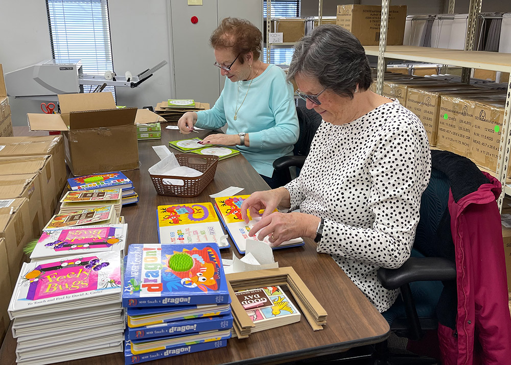 Chris and Pat Photo of two women volunteering to work on braille picture books.