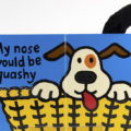 Interior spread for If I Were a Puppy with illustration of a puppy, touchable nose and tail, and braille sticker.