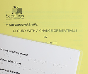 A cover for a Print-and-Braille Book in uncontracted UEB with an open page showing the line of print text followed by a line of braille