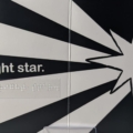 Interior spread of Holly Jolly with high contrast text, braille, and a black and white image of a star.