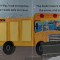 Interior spread of Hello World! Snow with descriptive print text, braille, and an illustration of a yellow snowplow.