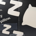 Interior spread of Hello, Bedtime with high contrast text, braille, and a black background with a white image of a pillow.