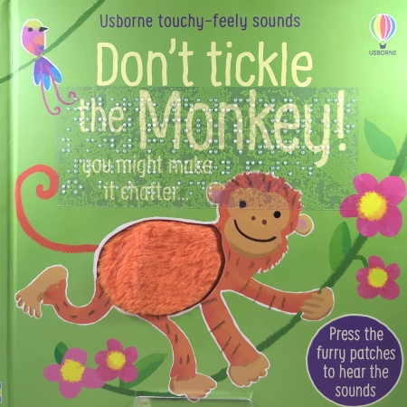 Cover of Don’t Tickle the Monkey! with a orange tactile monkey on a green book with print and transcribed braille