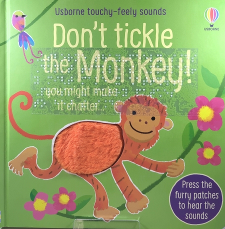 Cover of Don’t Tickle the Monkey! with a orange tactile monkey on a green book with print and transcribed braille