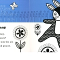 The inside of the picture book depicts a half blue half white background with swirly plants and butterflies. The main focus is a black bunny with flower print chasing a butterfly in a patch of flowers.