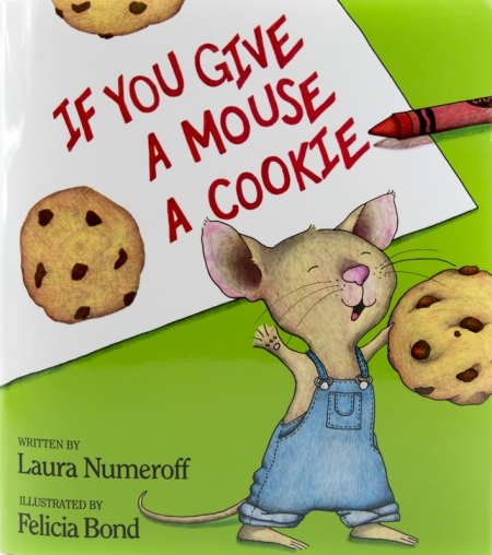A cartoon mouse wearing denim overalls joyously holds a large cookie.