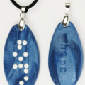 Braille clay charm necklace that says hope